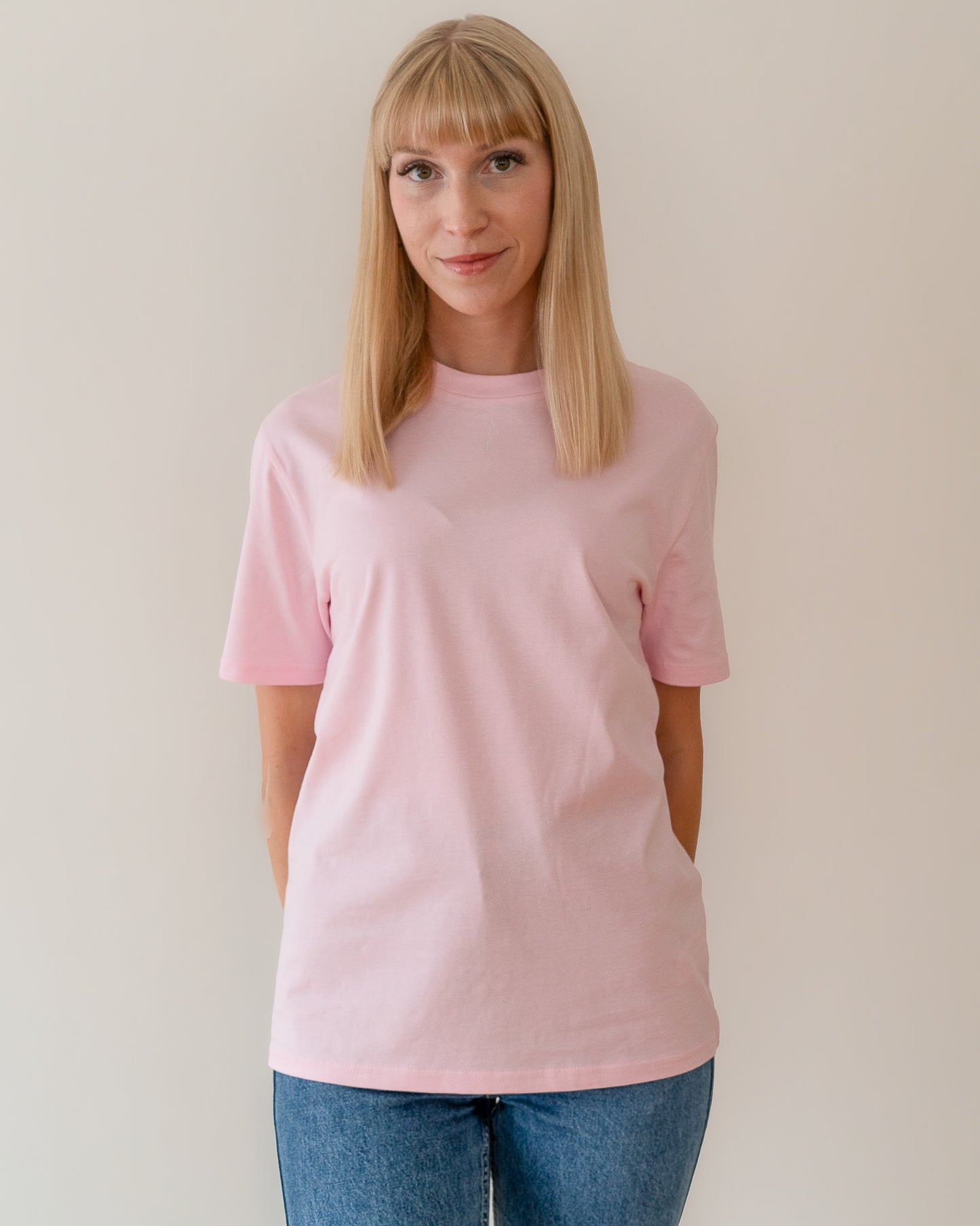 TESSERA t-shirt in lavender, worn by a woman, worn loose, AVE lettering at the neckline