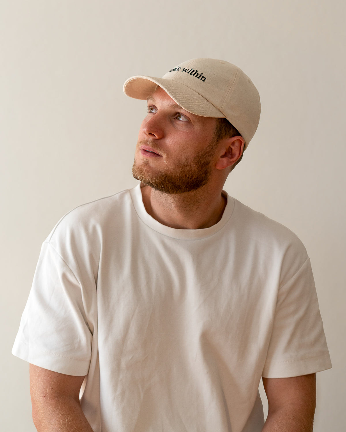 AVE dad cap in beige, worn by a man, begin within embroidery