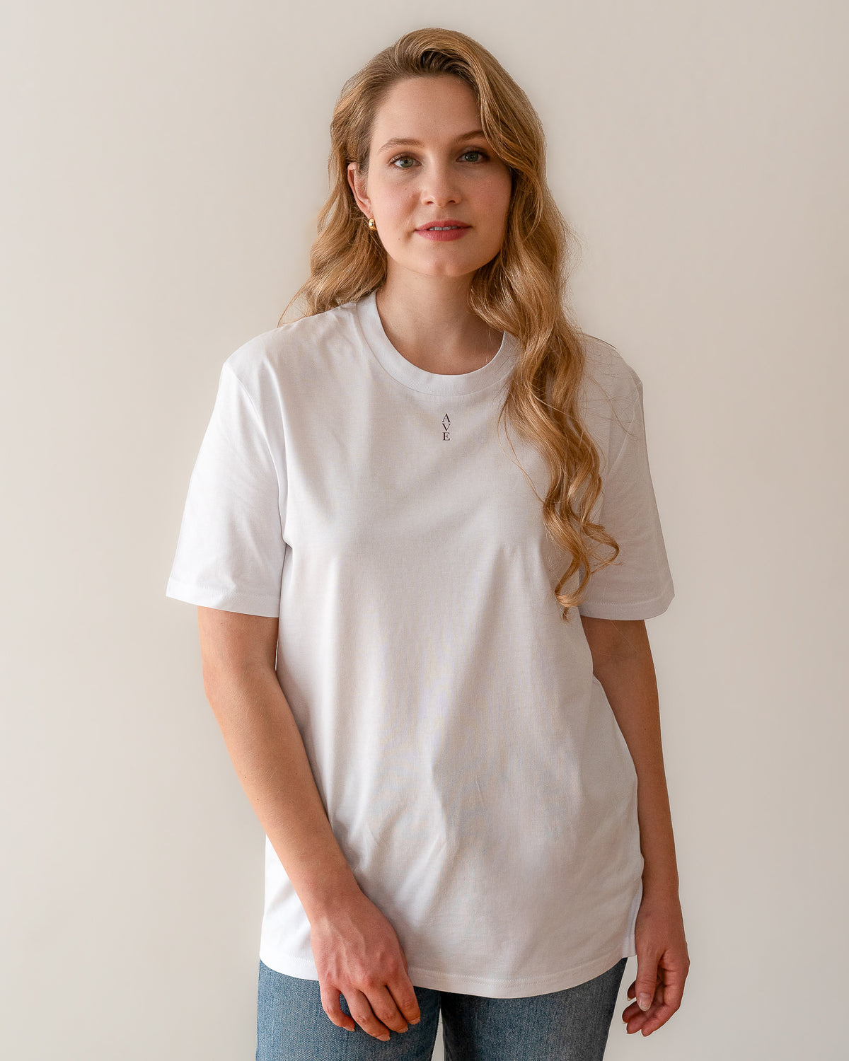 TESSERA t-shirt in lavender, worn by a woman, worn loose, AVE lettering at the neckline