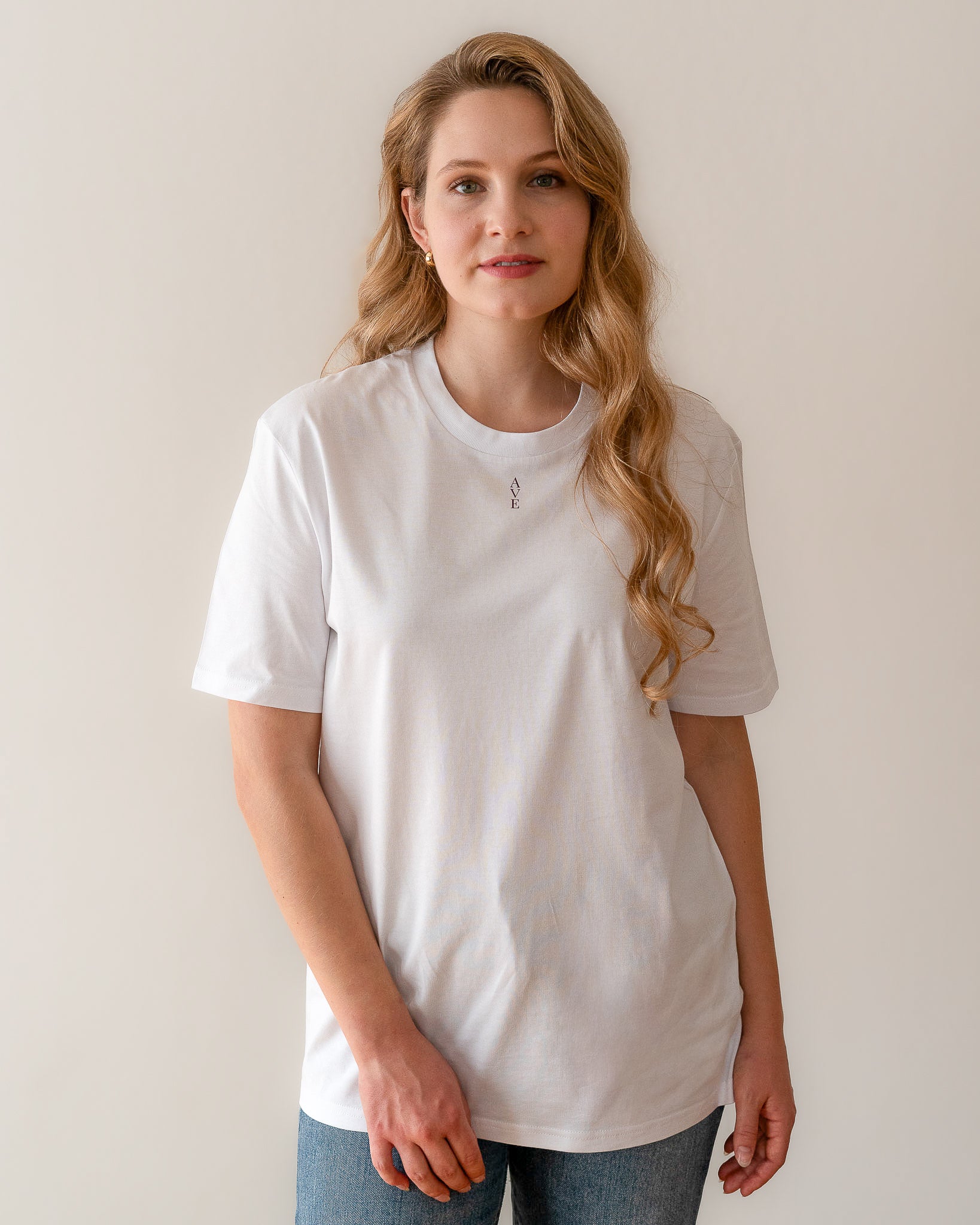 TESSERA t-shirt in lavender, worn by a woman, worn loose, AVE lettering at the neckline