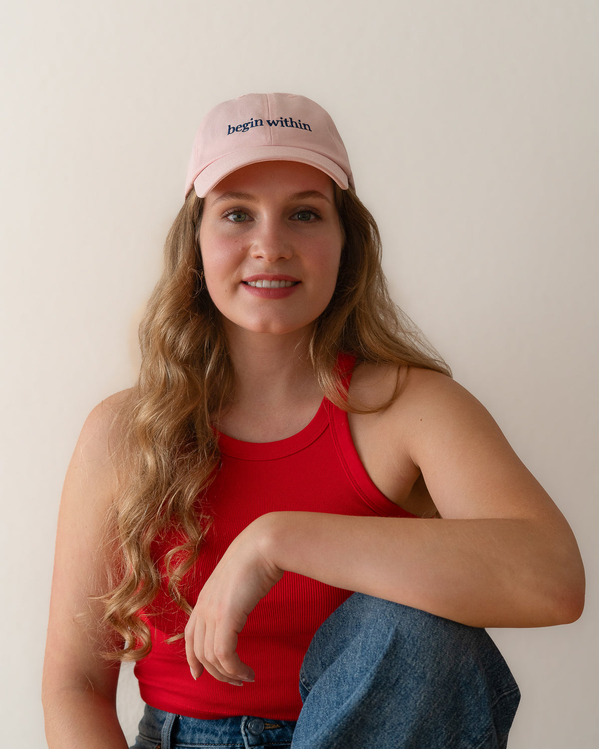 AVE dad cap in pink, worn by a woman, begin within embroidery