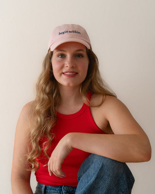 AVE dad cap in pink, worn by a woman, begin within embroidery