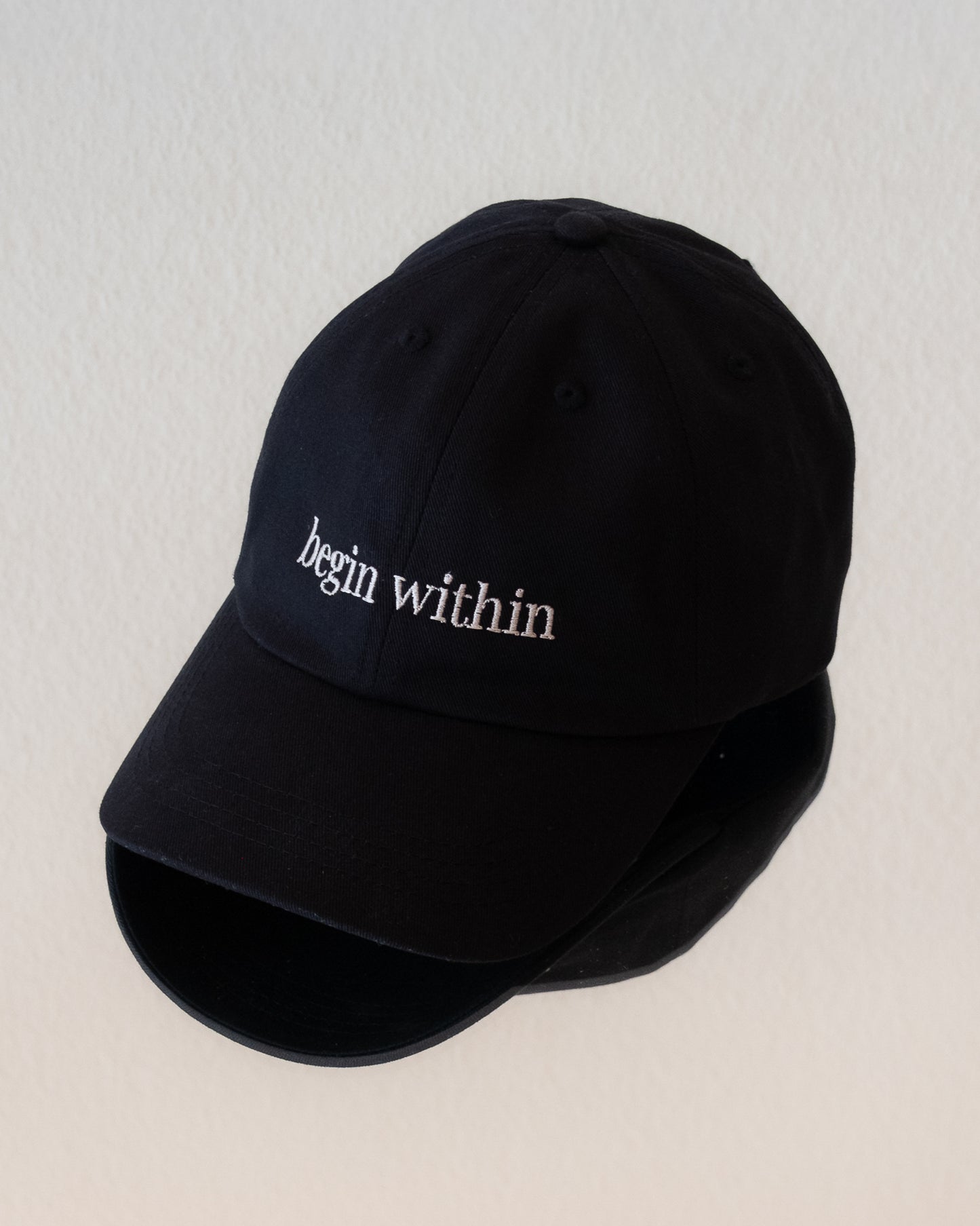 AVE dad cap in black, front view, begin within embroidery