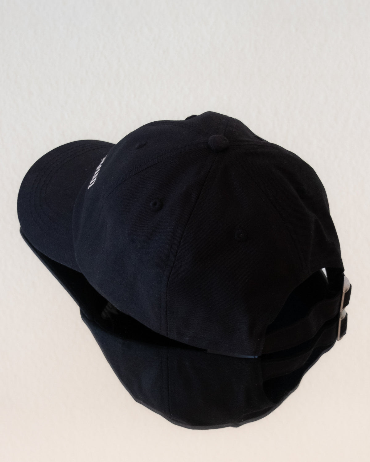 AVE dad cap in black, back view, brass closure