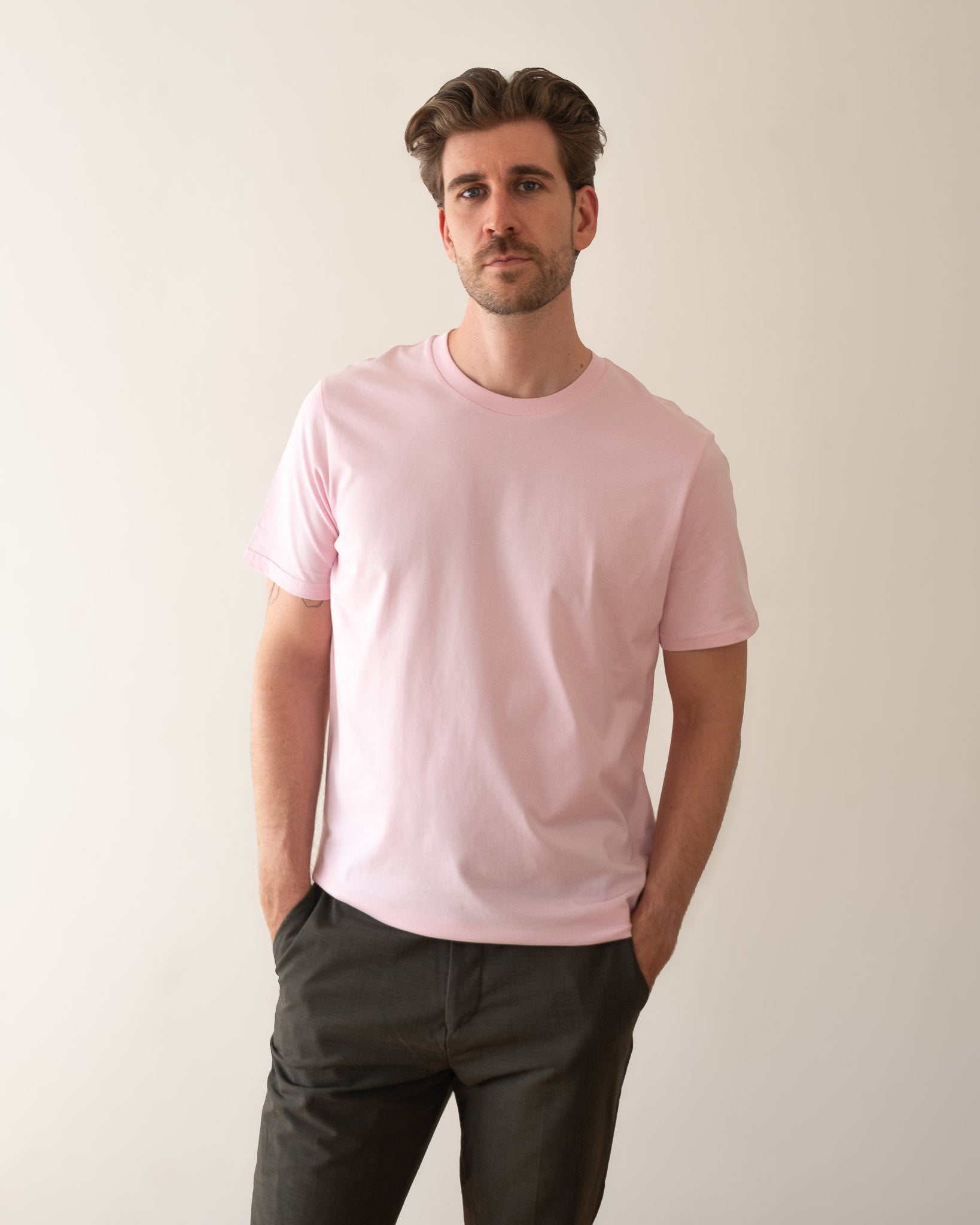 TESSERA t-shirt in pink, worn by a man, worn loose, AVE lettering at the neckline