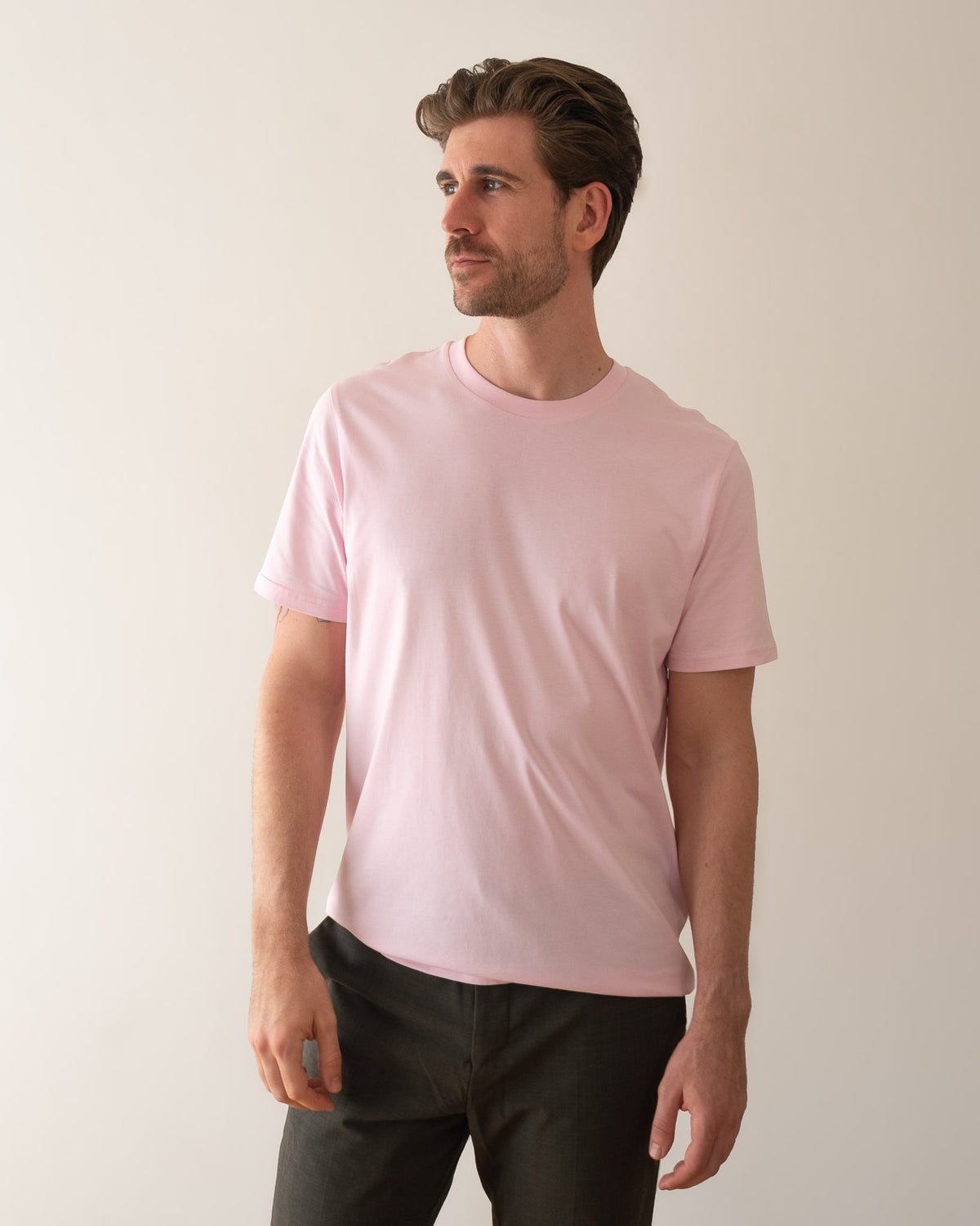 TESSERA t-shirt in pink, worn by a man, worn loose, AVE lettering at the neckline